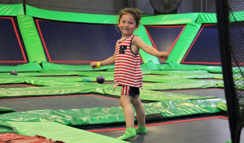 Little girl jumping on a trampoline at BRAVOZ